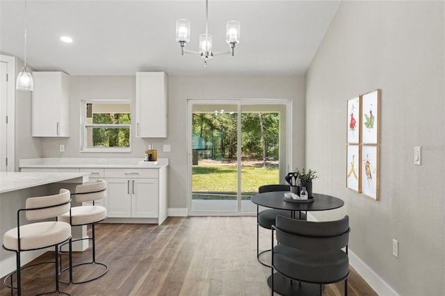 8782 N Sandree Dr, Citrus Springs, FL 34434 - dining room with light wood-style floors, plenty of natural light, and a chandelier