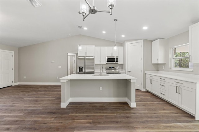 8782 N Sandree Dr, Citrus Springs, FL 34434 - kitchen with stainless steel appliances, vaulted ceiling, a center island with sink, white cabinetry, and light countertops