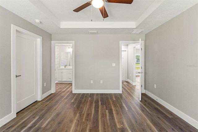 8782 N Sandree Dr, Citrus Springs, FL 34434 - unfurnished bedroom with a raised ceiling, dark wood finished floors, and ensuite bathroom