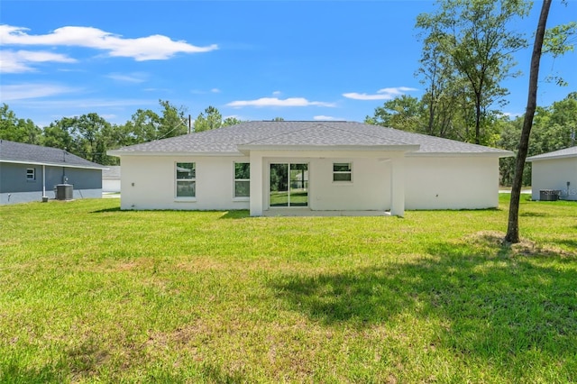 8782 N Sandree Dr, Citrus Springs, FL 34434 - rear view of property featuring a lawn, stucco siding, and a shingled roof