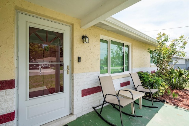 10600 Oleander Dr, Port Richey, FL 34668 - view of exterior entry with brick siding and stucco siding
