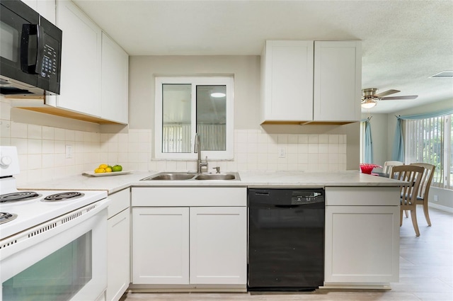 10600 Oleander Dr, Port Richey, FL 34668 - kitchen with black appliances, white cabinetry, light countertops, and backsplash
