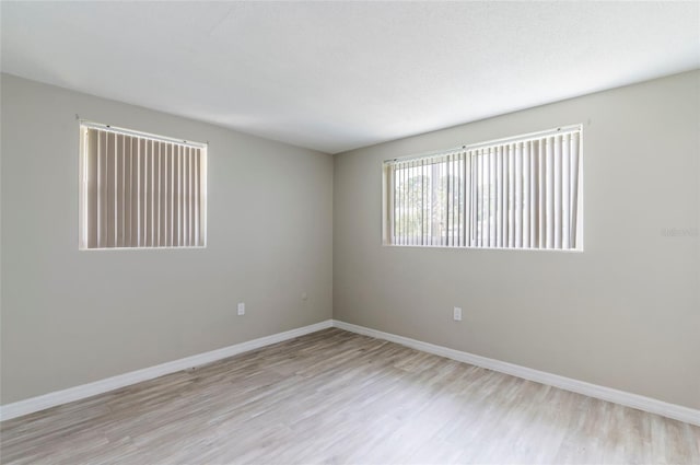 10600 Oleander Dr, Port Richey, FL 34668 - empty room featuring wood finished floors and baseboards