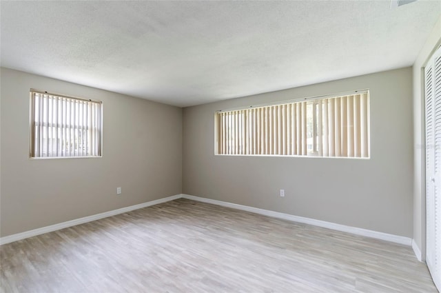 10600 Oleander Dr, Port Richey, FL 34668 - spare room with light wood-style floors and a textured ceiling