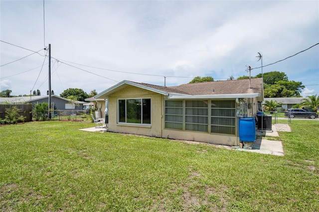 10600 Oleander Dr, Port Richey, FL 34668 - back of house with stucco siding and a sunroom