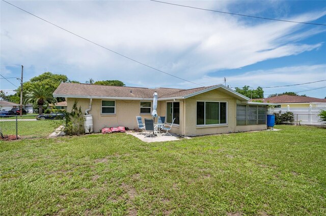 10600 Oleander Dr, Port Richey, FL 34668 - back of house featuring stucco siding and a patio