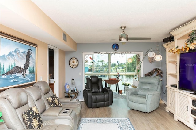 4939 Floramar Ter Unit 203, New Port Richey, FL 34652 - living room with light wood-style floors and a ceiling fan