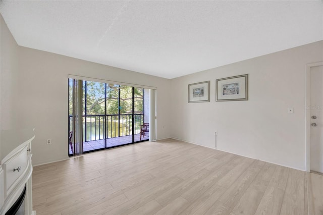 3134 Lake Pine Way Unit F2, Tarpon Springs, FL 34688 - unfurnished living room featuring light wood finished floors