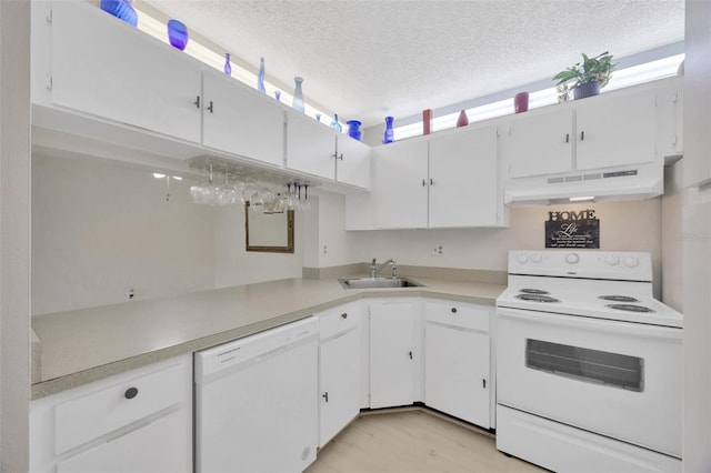 3134 Lake Pine Way Unit F2, Tarpon Springs, FL 34688 - kitchen featuring white appliances, under cabinet range hood, white cabinets, a textured ceiling, and light countertops