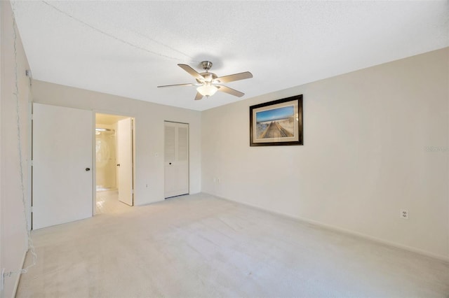 3134 Lake Pine Way Unit F2, Tarpon Springs, FL 34688 - unfurnished bedroom with light colored carpet, ensuite bath, and a ceiling fan
