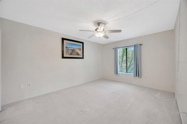 3134 Lake Pine Way Unit F2, Tarpon Springs, FL 34688 - empty room featuring light carpet, a ceiling fan, and a textured ceiling