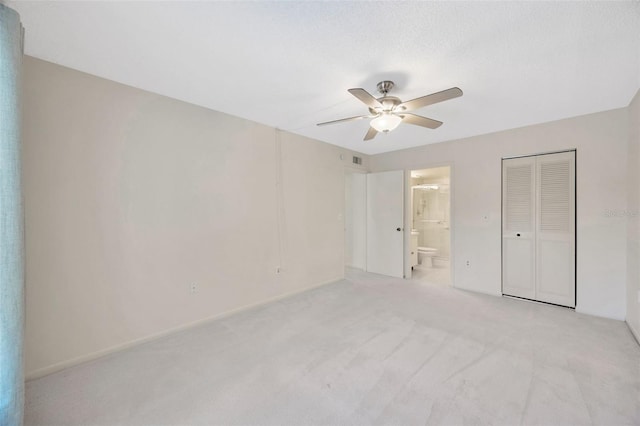 3134 Lake Pine Way Unit F2, Tarpon Springs, FL 34688 - unfurnished bedroom featuring light colored carpet, ensuite bath, a closet, and a ceiling fan