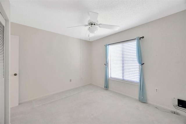 3134 Lake Pine Way Unit F2, Tarpon Springs, FL 34688 - empty room featuring light colored carpet, ceiling fan, and a textured ceiling
