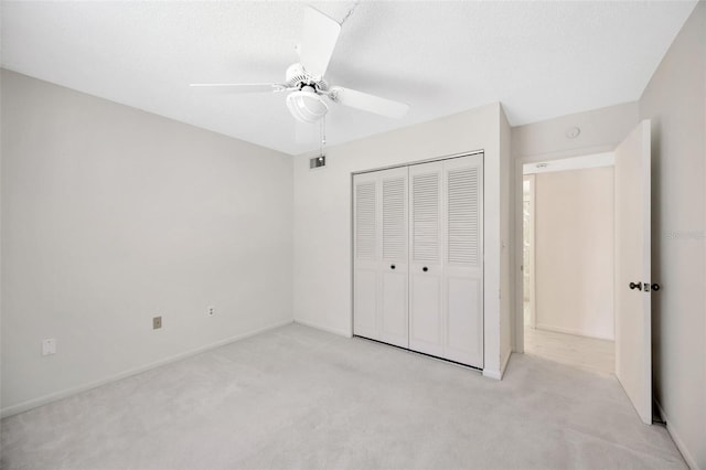 3134 Lake Pine Way Unit F2, Tarpon Springs, FL 34688 - unfurnished bedroom featuring light carpet, a closet, and a ceiling fan