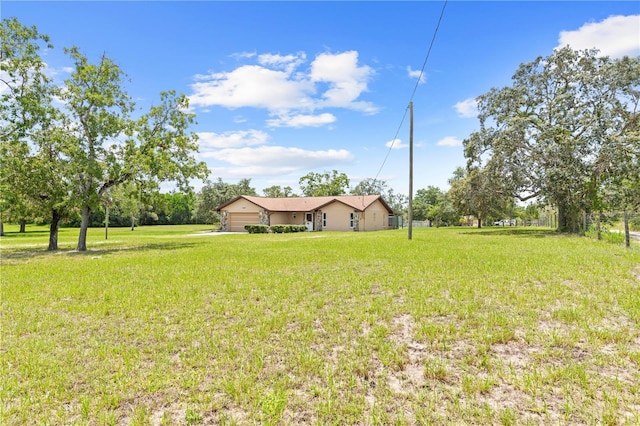13180 Montour St, Brooksville, FL 34613 - view of green lawn with a garage
