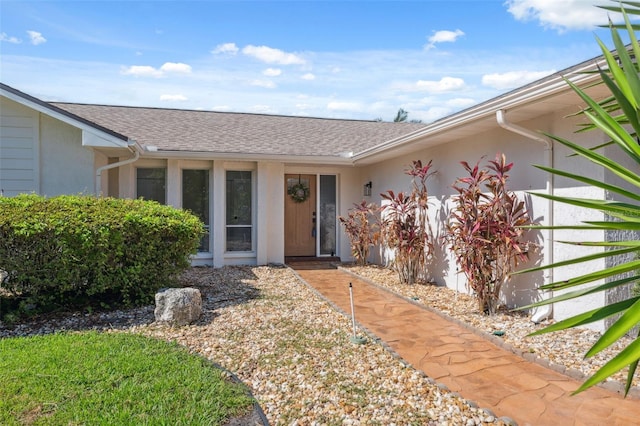 5348 Lawrence Ln, New Port Richey, FL 34652 - entrance to property featuring stucco siding and roof with shingles