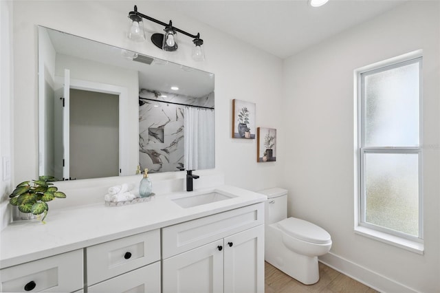 5348 Lawrence Ln, New Port Richey, FL 34652 - full bath featuring vanity, curtained shower, and wood finished floors