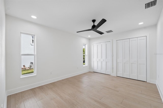 5348 Lawrence Ln, New Port Richey, FL 34652 - unfurnished bedroom featuring multiple closets, light wood-style flooring, recessed lighting, and ceiling fan