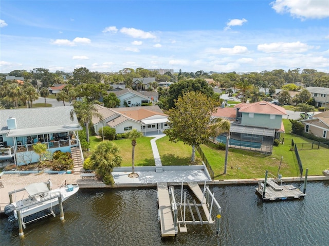 5348 Lawrence Ln, New Port Richey, FL 34652 - dock with a residential view, a water view, boat lift, and a lawn