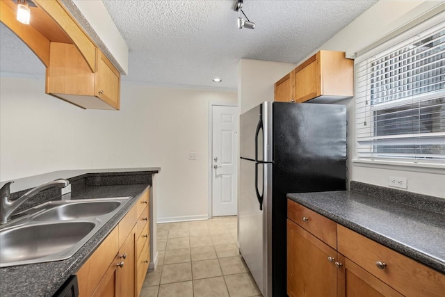 2500 Winding Creek Blvd Unit G106, Clearwater, FL 33761 - kitchen featuring freestanding refrigerator, dark countertops, a textured ceiling, light tile patterned floors, and dishwasher
