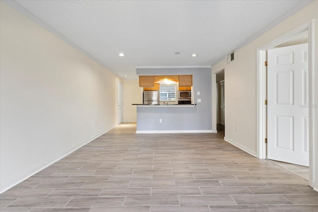 2500 Winding Creek Blvd Unit G106, Clearwater, FL 33761 - unfurnished living room featuring recessed lighting, light wood-type flooring, a textured ceiling, and ornamental molding