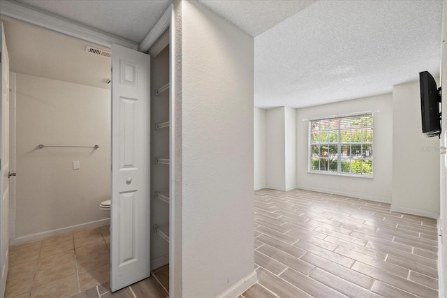 2500 Winding Creek Blvd Unit G106, Clearwater, FL 33761 - corridor featuring a textured ceiling and wood finished floors