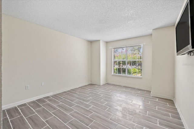 2500 Winding Creek Blvd Unit G106, Clearwater, FL 33761 - empty room with a textured ceiling and wood tiled floors