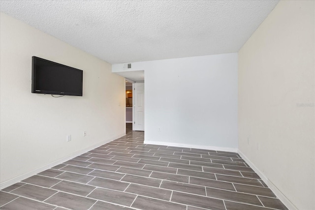 2500 Winding Creek Blvd Unit G106, Clearwater, FL 33761 - spare room featuring wood finished floors and a textured ceiling