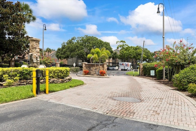 2500 Winding Creek Blvd Unit G106, Clearwater, FL 33761 - view of street featuring street lights, a gate, a gated entry, and curbs