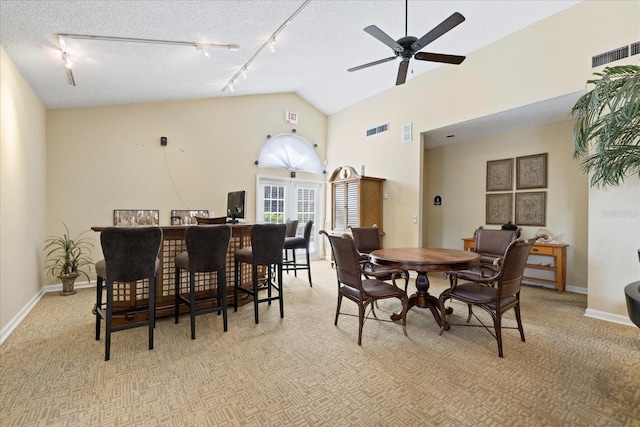 2500 Winding Creek Blvd Unit G106, Clearwater, FL 33761 - dining room featuring track lighting, a ceiling fan, light carpet, a textured ceiling, and high vaulted ceiling
