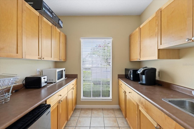 2500 Winding Creek Blvd Unit G106, Clearwater, FL 33761 - kitchen with white microwave, black microwave, light tile patterned flooring, dishwasher, and dark countertops