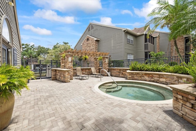 2500 Winding Creek Blvd Unit G106, Clearwater, FL 33761 - view of pool with a hot tub, a pergola, a patio area, and a gate