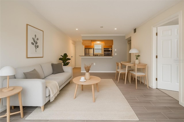 2500 Winding Creek Blvd Unit G106, Clearwater, FL 33761 - living room featuring wood finished floors, recessed lighting, and crown molding