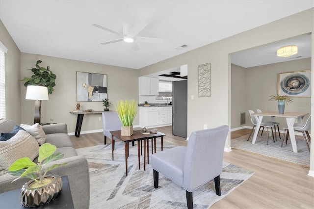 2954 Leisure Ct, Dunedin, FL 34698 - living area featuring light wood-type flooring and a ceiling fan