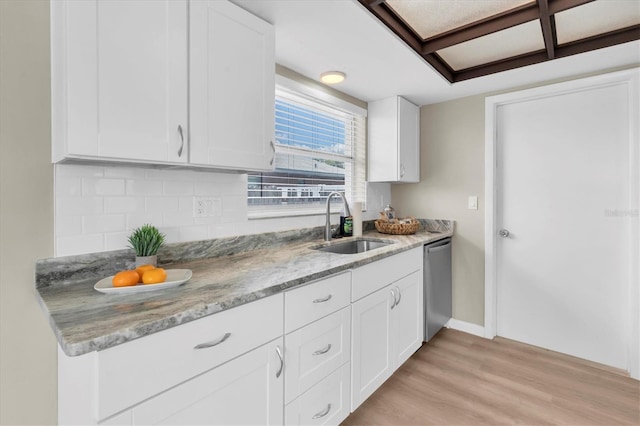 2954 Leisure Ct, Dunedin, FL 34698 - kitchen featuring light wood-type flooring, tasteful backsplash, light stone countertops, dishwasher, and white cabinets