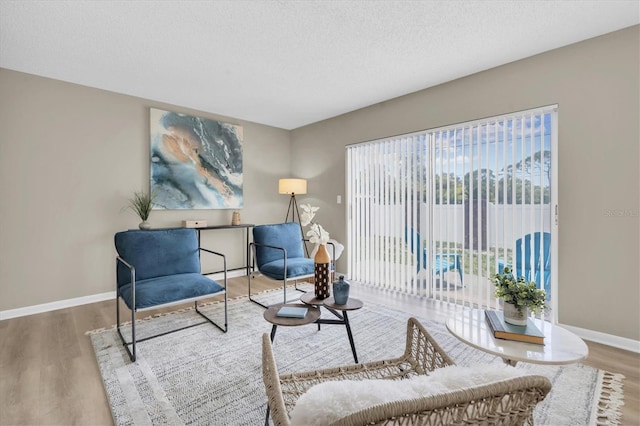 2954 Leisure Ct, Dunedin, FL 34698 - sitting room featuring wood finished floors and a textured ceiling