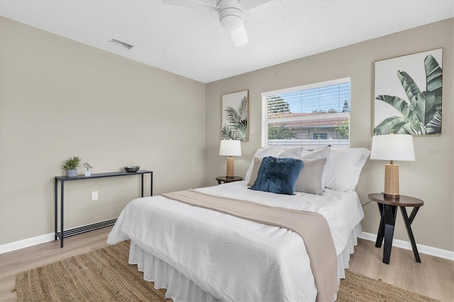 2954 Leisure Ct, Dunedin, FL 34698 - bedroom featuring wood finished floors, a ceiling fan, and a textured ceiling