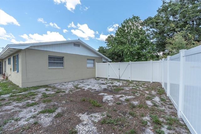 2954 Leisure Ct, Dunedin, FL 34698 - rear view of property with a gate and a fenced backyard