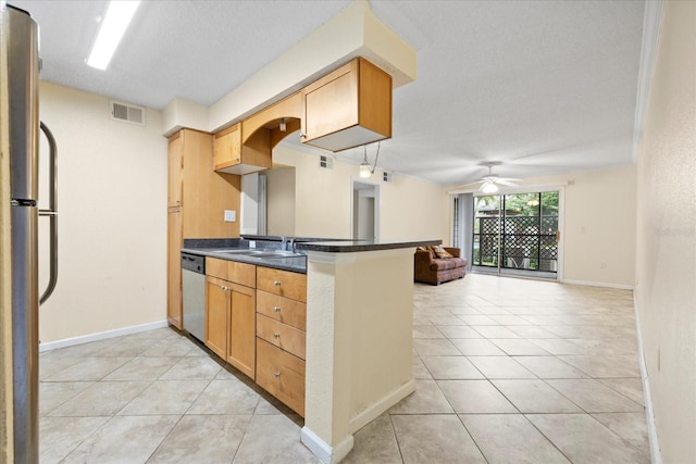 2500 Winding Creek Blvd Unit I106, Clearwater, FL 33761 - kitchen featuring stainless steel appliances, dark countertops, a ceiling fan, light tile patterned flooring, and open floor plan