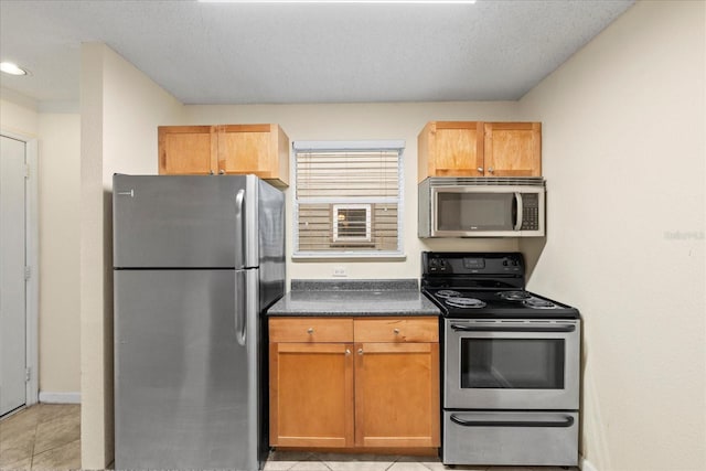 2500 Winding Creek Blvd Unit I106, Clearwater, FL 33761 - kitchen featuring appliances with stainless steel finishes, dark countertops, light tile patterned flooring, and recessed lighting