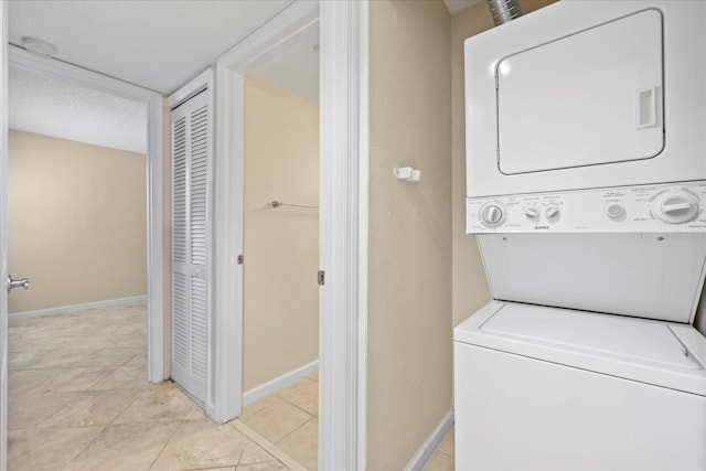 2500 Winding Creek Blvd Unit I106, Clearwater, FL 33761 - laundry area featuring estacked washer and dryer and light tile patterned flooring