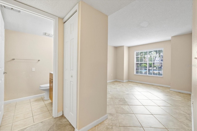 2500 Winding Creek Blvd Unit I106, Clearwater, FL 33761 - bathroom featuring tile patterned flooring, vanity, a textured ceiling, and a closet