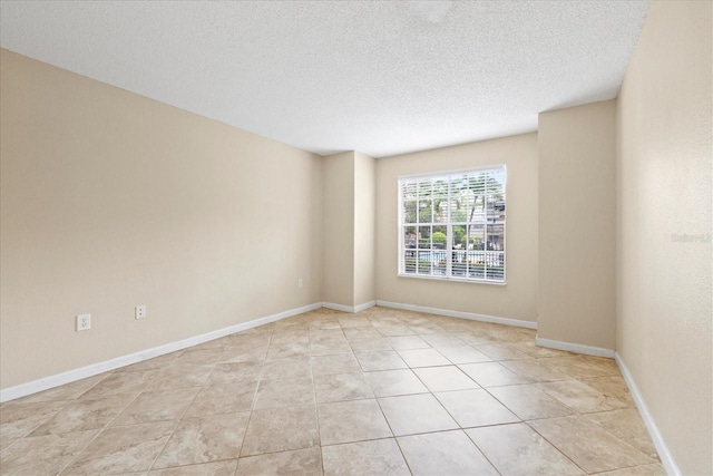 2500 Winding Creek Blvd Unit I106, Clearwater, FL 33761 - spare room featuring a textured ceiling and light tile patterned floors