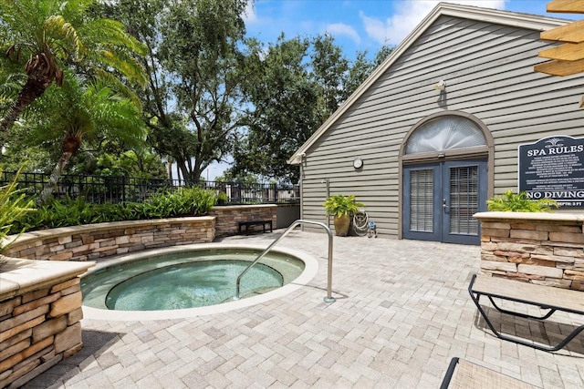 2500 Winding Creek Blvd Unit I106, Clearwater, FL 33761 - view of swimming pool featuring french doors, a hot tub, and a patio