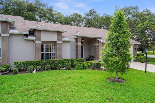 7445 Nature Walk Dr, Spring Hill, FL 34606 - view of front facade featuring roof with shingles, a front lawn, brick siding, and concrete driveway
