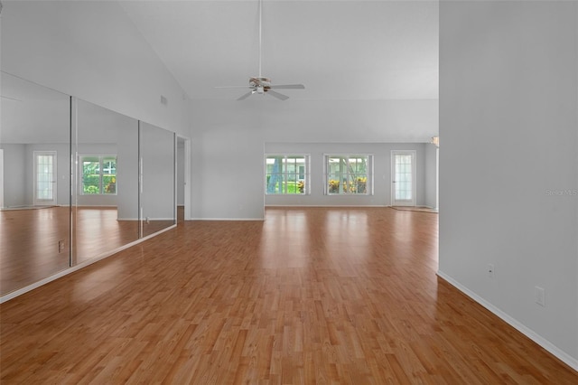 7445 Nature Walk Dr, Spring Hill, FL 34606 - unfurnished living room with ceiling fan, light wood-style flooring, plenty of natural light, and high vaulted ceiling