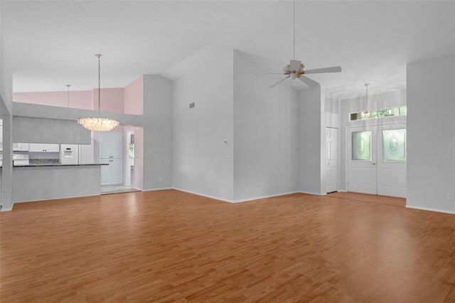 7445 Nature Walk Dr, Spring Hill, FL 34606 - unfurnished living room featuring a chandelier, light wood-style flooring, a ceiling fan, and high vaulted ceiling
