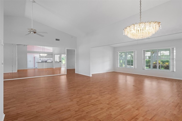 7445 Nature Walk Dr, Spring Hill, FL 34606 - unfurnished living room with a chandelier, high vaulted ceiling, ceiling fan, and light wood-style floors