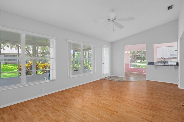 7445 Nature Walk Dr, Spring Hill, FL 34606 - spare room featuring light wood-style flooring, vaulted ceiling, and ceiling fan