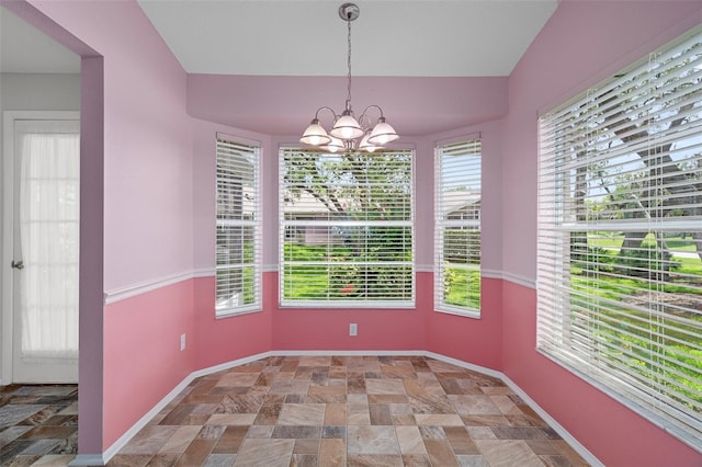 7445 Nature Walk Dr, Spring Hill, FL 34606 - unfurnished dining area with stone finish floors and a chandelier